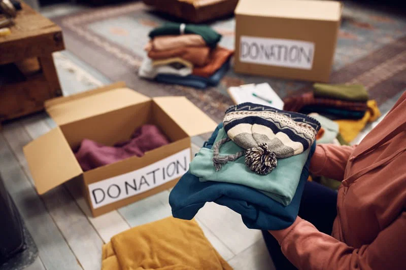 Donation boxes and neatly folded belongings