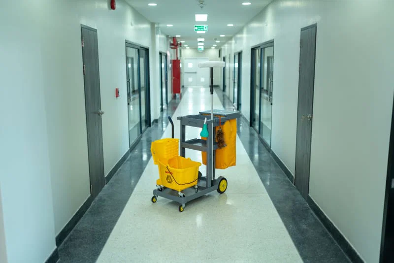 Cleaning trolley in a workplace corridor